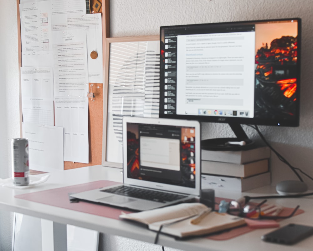 black flat screen computer monitor on white wooden desk