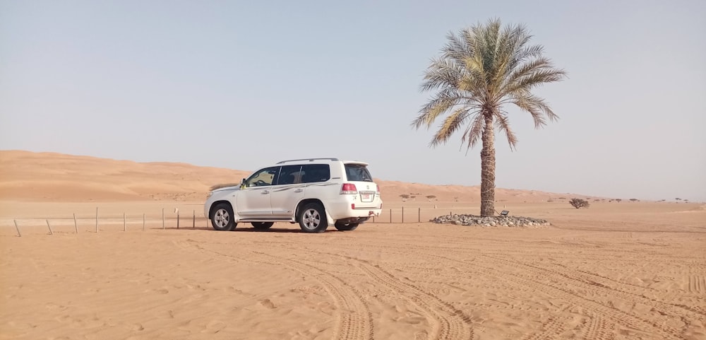 white suv on desert during daytime