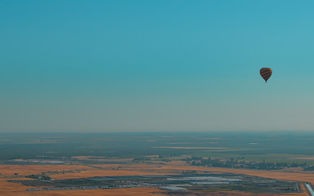 brown field under blue sky during daytime