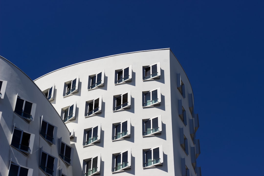a tall white building with lots of windows,