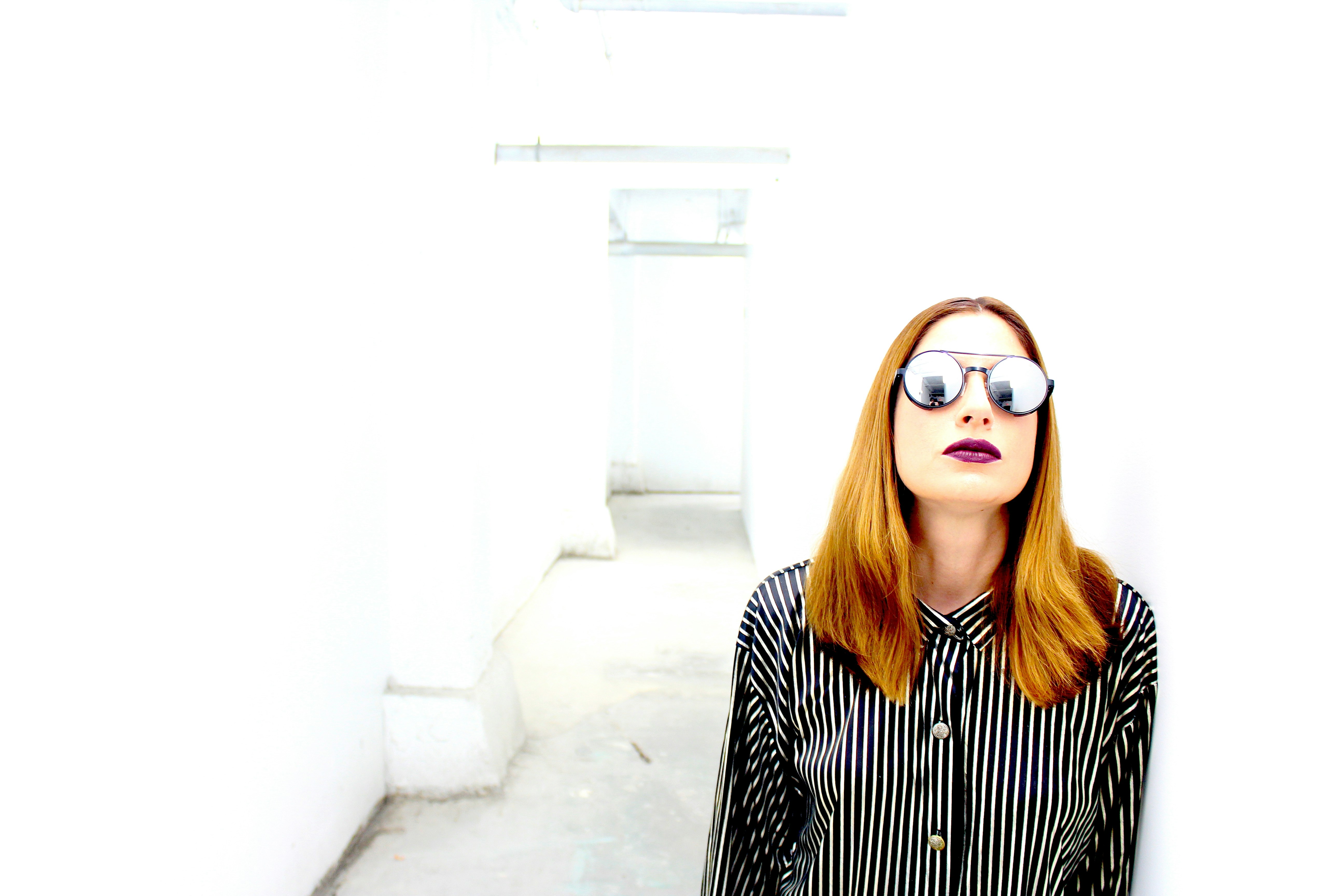 woman in black and white striped long sleeve shirt wearing brown sunglasses