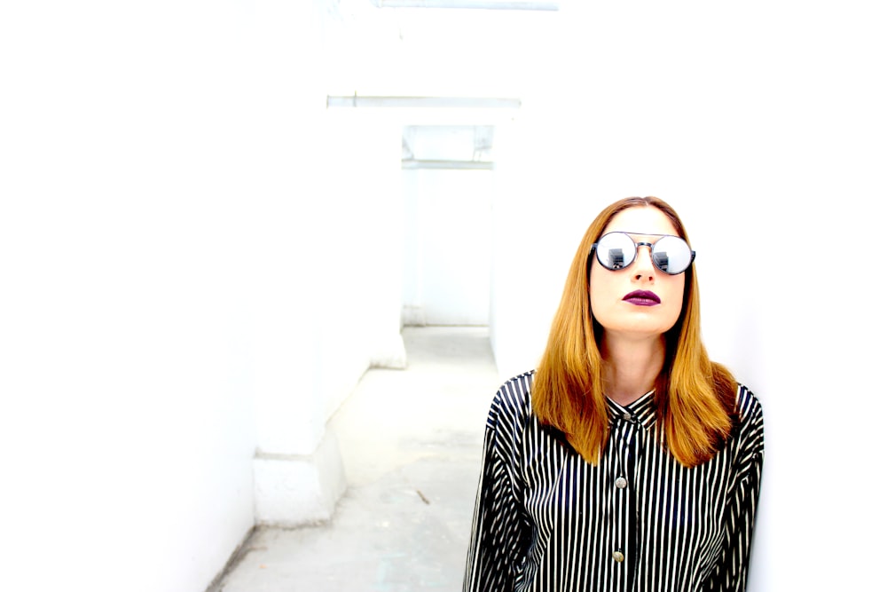 woman in black and white striped long sleeve shirt wearing brown sunglasses