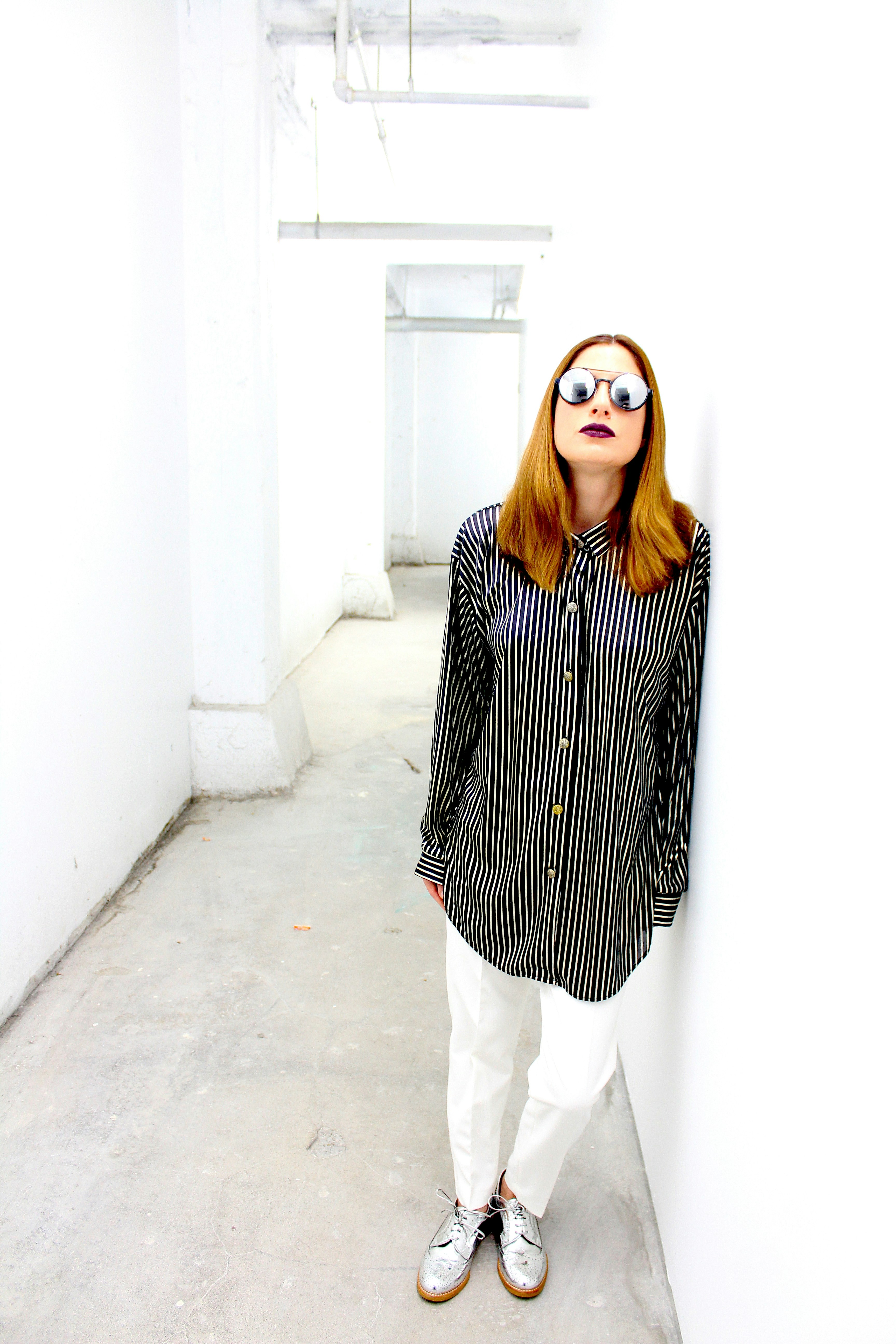 woman in black and white checkered coat and white pants