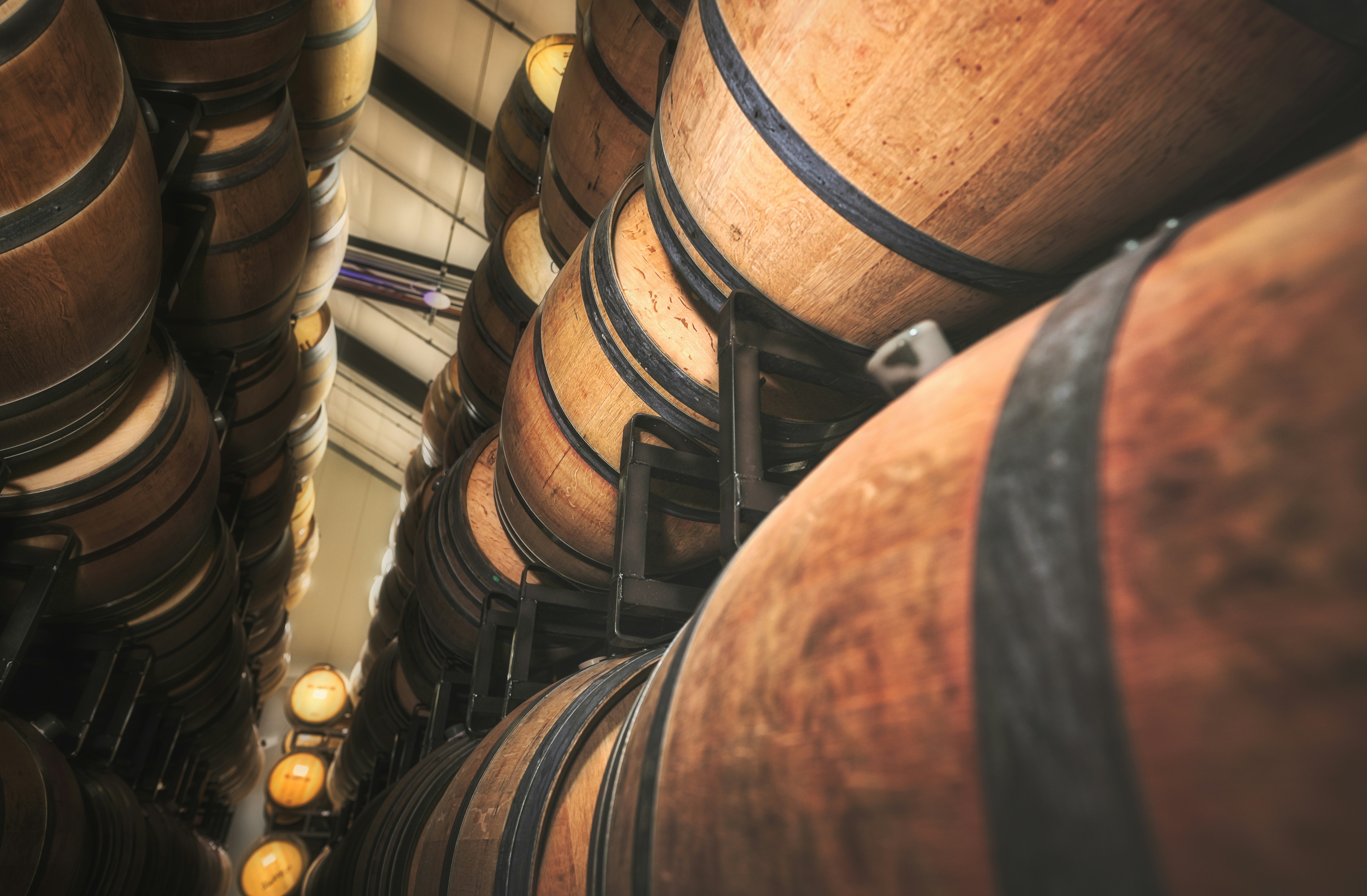 brown wooden barrels with yellow light, Wine barrels lined up.