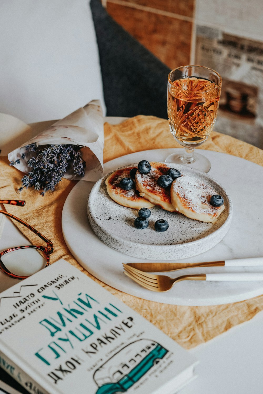 brown and black pastry on white ceramic plate beside clear wine glass