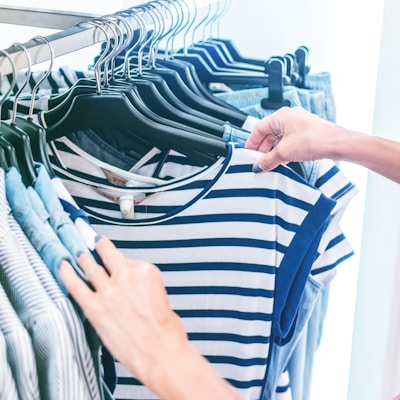 person holding white and black striped shirt