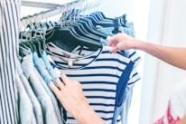 person holding white and black striped shirt