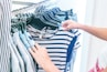 person holding white and black striped shirt