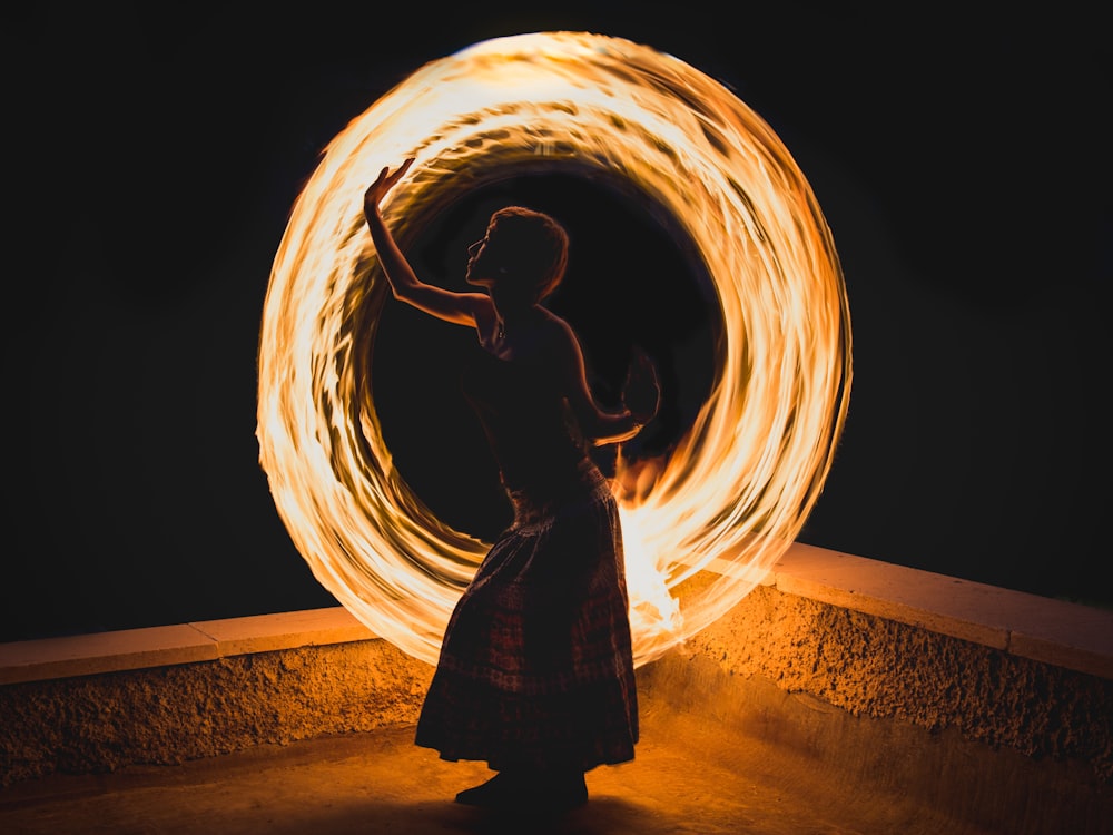 woman in black dress standing on tunnel