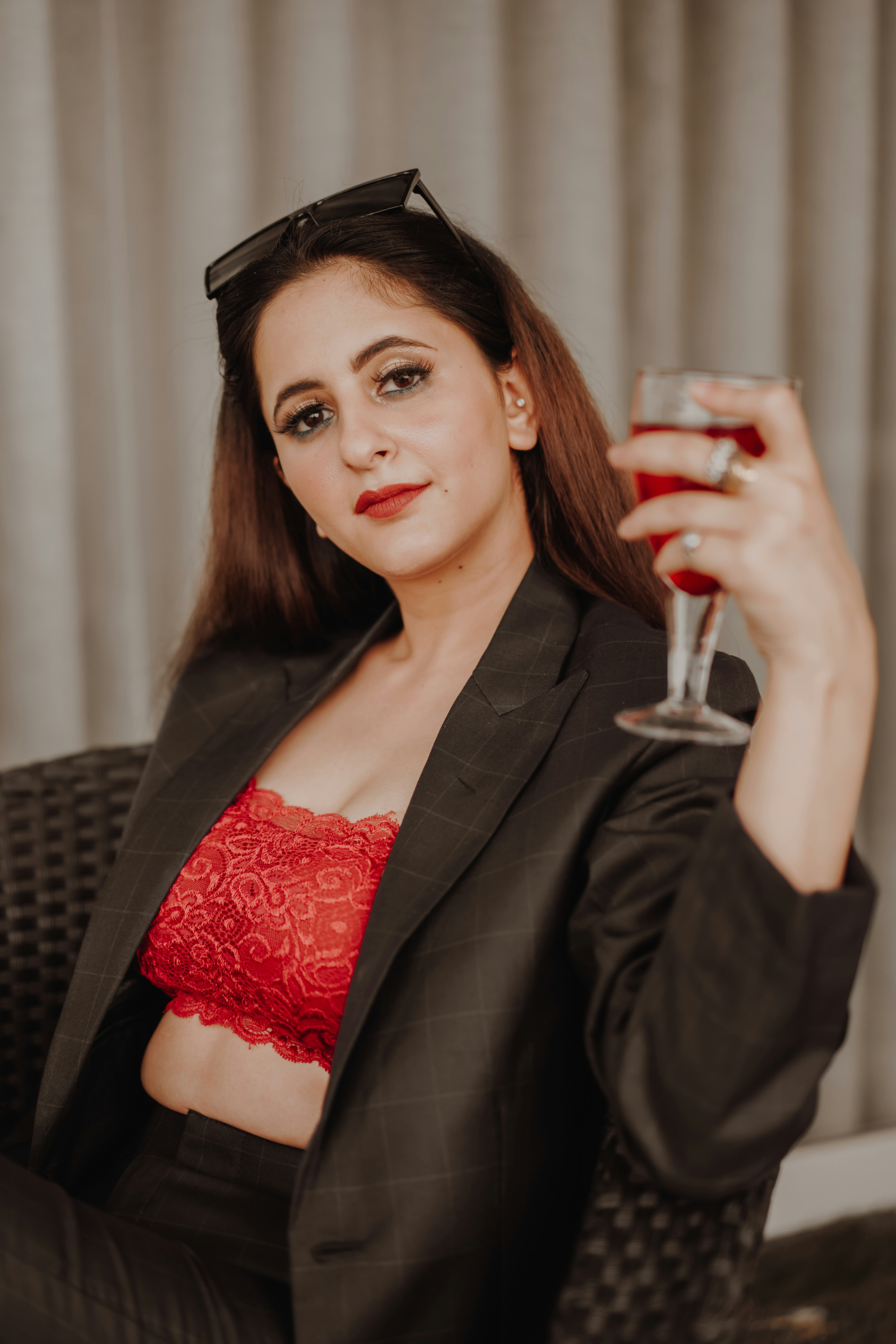 woman in red floral lace brassiere and black blazer