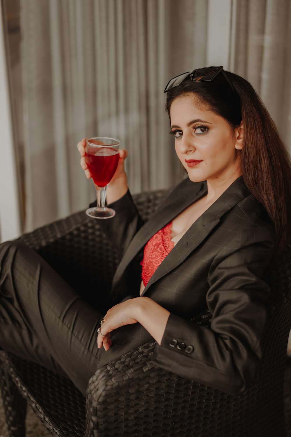 woman in black blazer holding wine glass