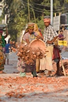 Volunteers laying bricks together, hands dusty but spirits high.