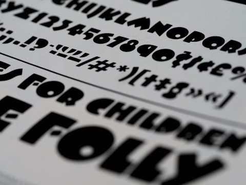 Minimalist black and white typography samples layered over textured paper.