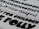 A selection of bold, black typography on a white paper background, featuring a variety of fonts and characters. These include uppercase and lowercase letters, numbers, and symbols.