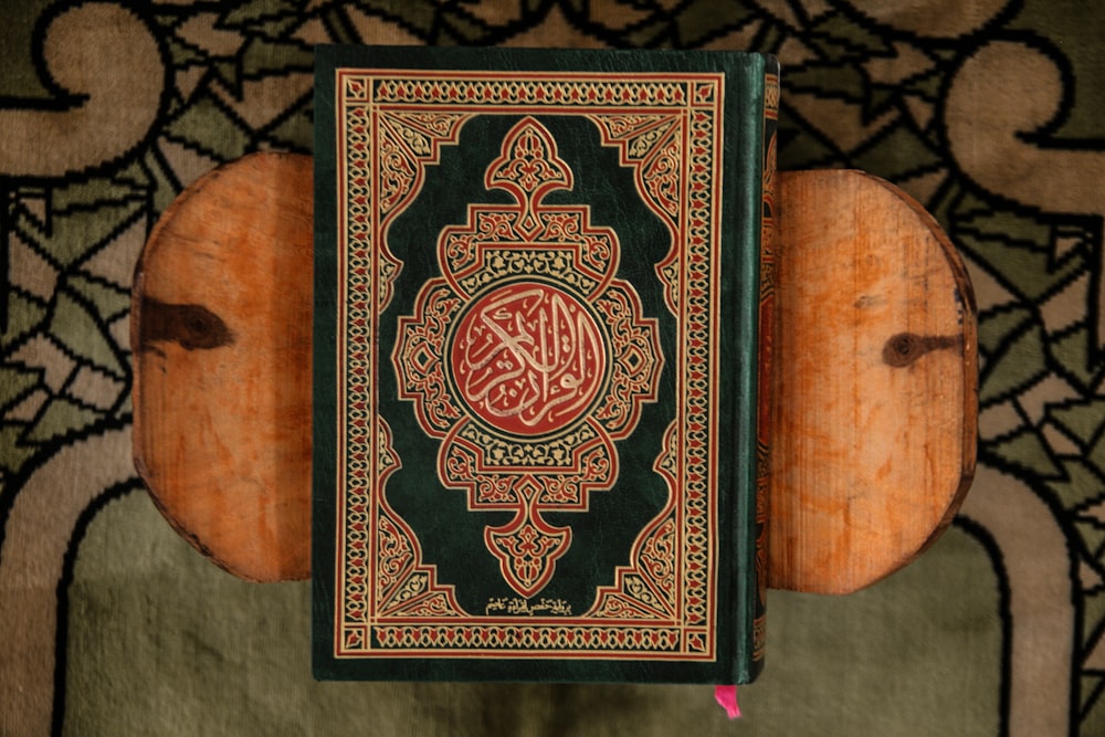 black and red book on brown wooden table