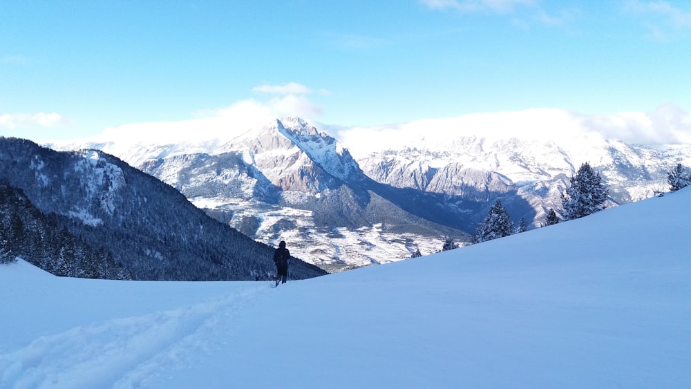 person walking on snow covered ground during daytime