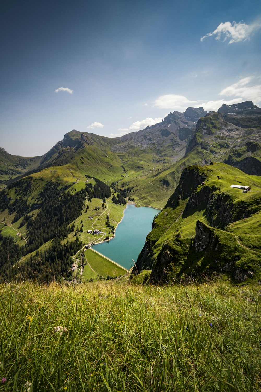 green mountains near body of water during daytime