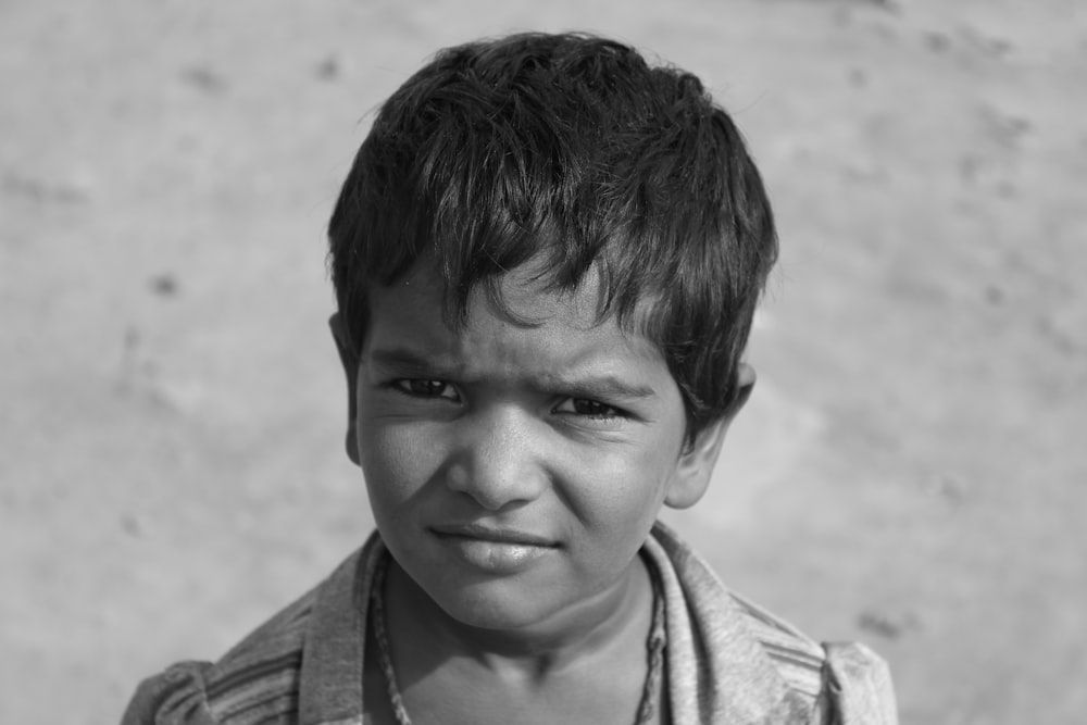 grayscale photo of boy in collared shirt