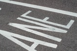 Close-up of freshly painted road markings on an urban street.