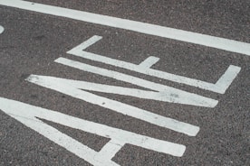 A close-up of freshly painted road markings.