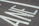 Close-up of freshly painted bright white road markings on an urban street.