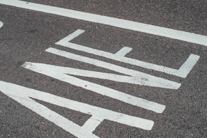 Close-up of freshly painted road markings on an urban street.