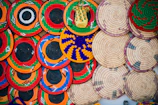 A colorful display of woven baskets made from natural fibers.