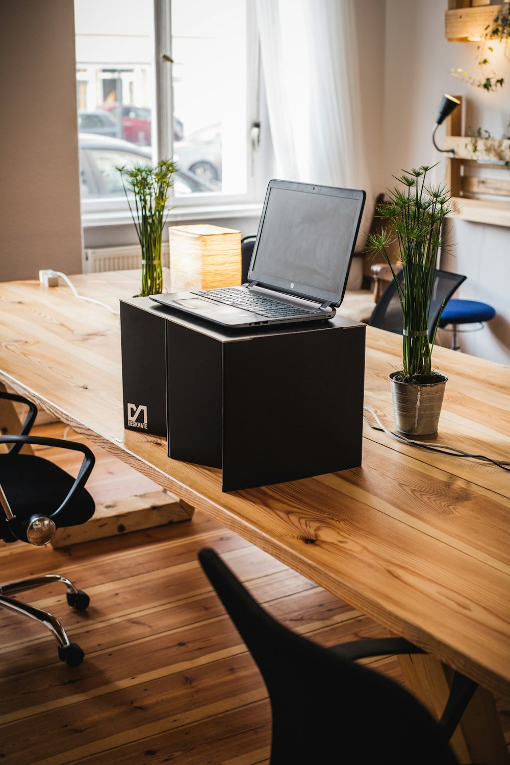 black laptop computer on brown wooden table