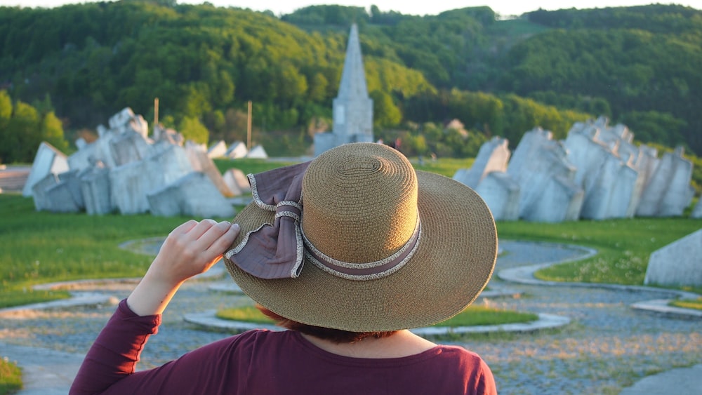 person in brown hat and red shirt