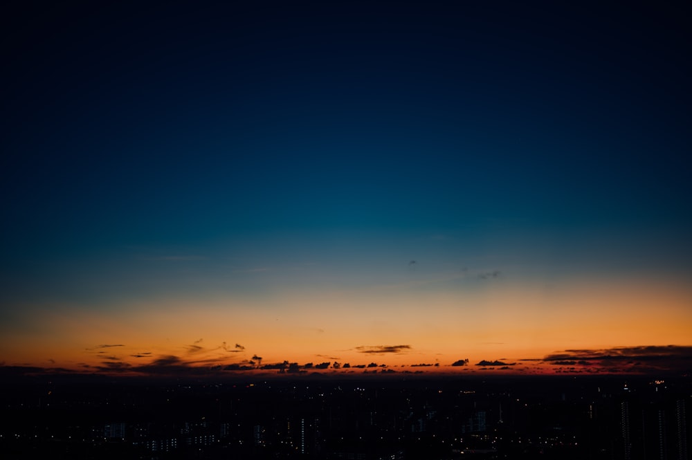 silhouette of city buildings during sunset