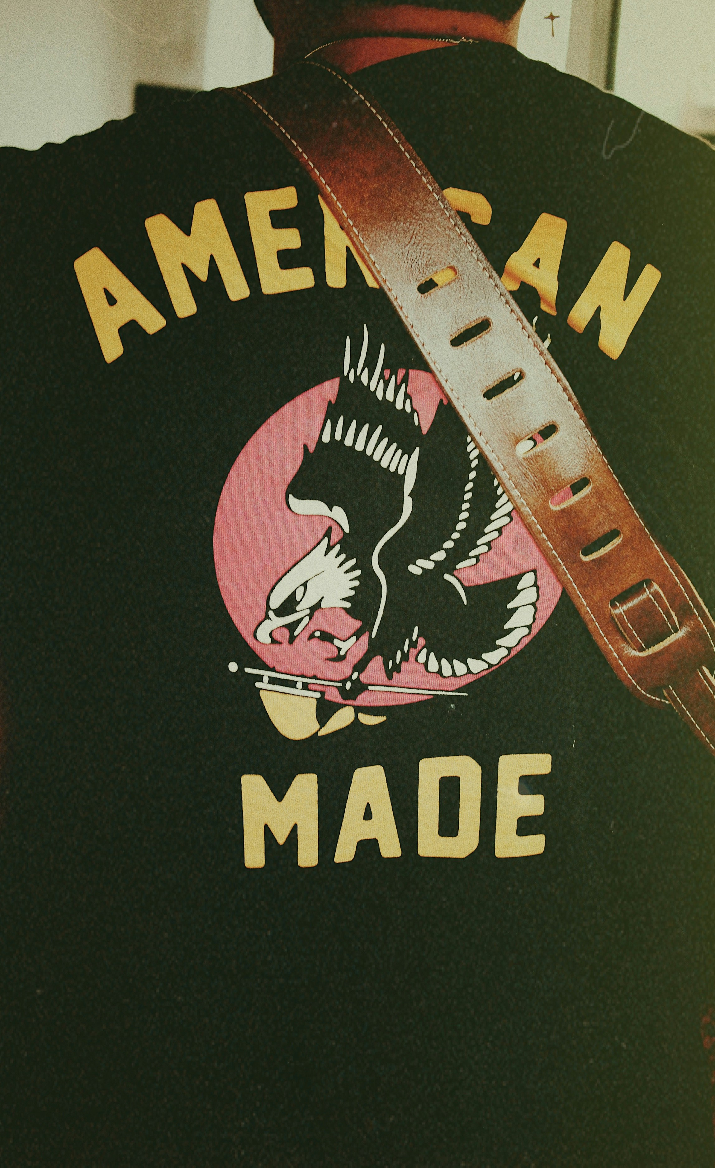the back of a man wearing a black american made vest