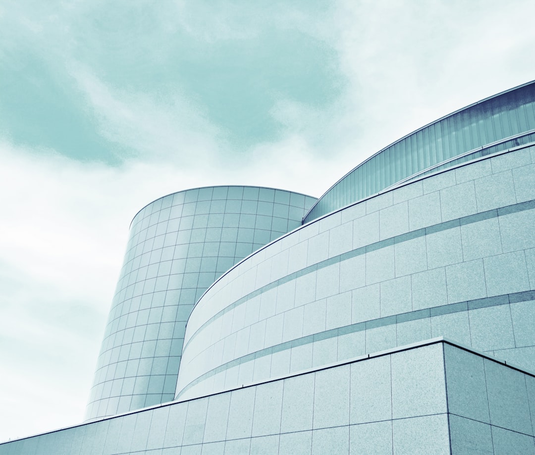 gray concrete building under white clouds during daytime