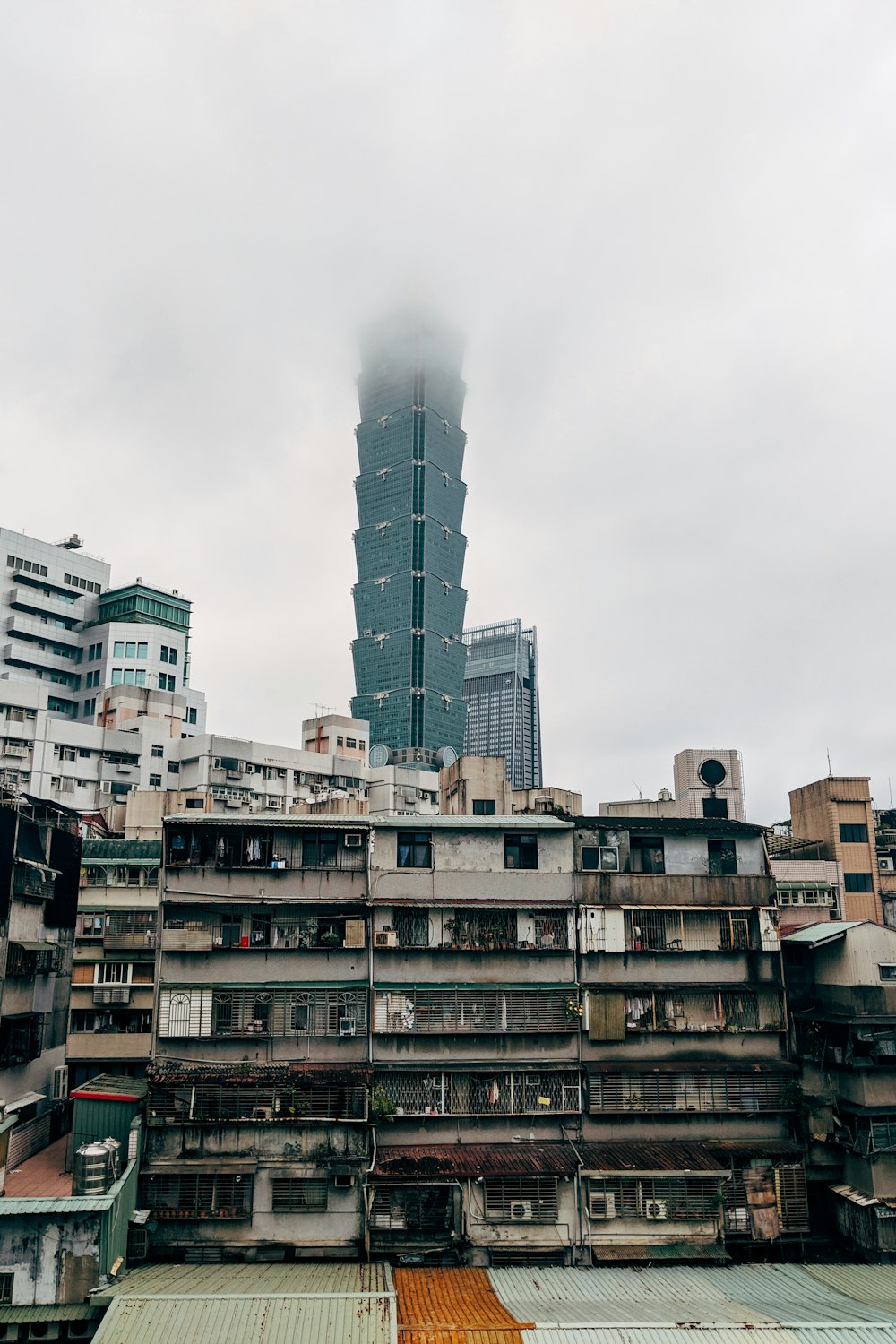 white and brown concrete building under white clouds during daytime