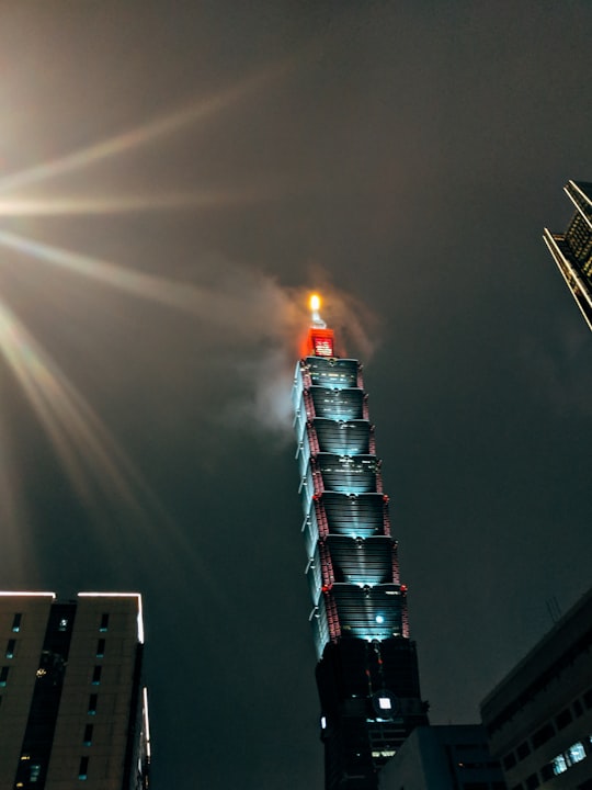 red and white tower with fire during night time in Xiangshan Park Taiwan