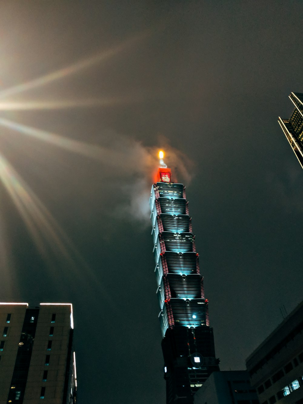 red and white tower with fire during night time