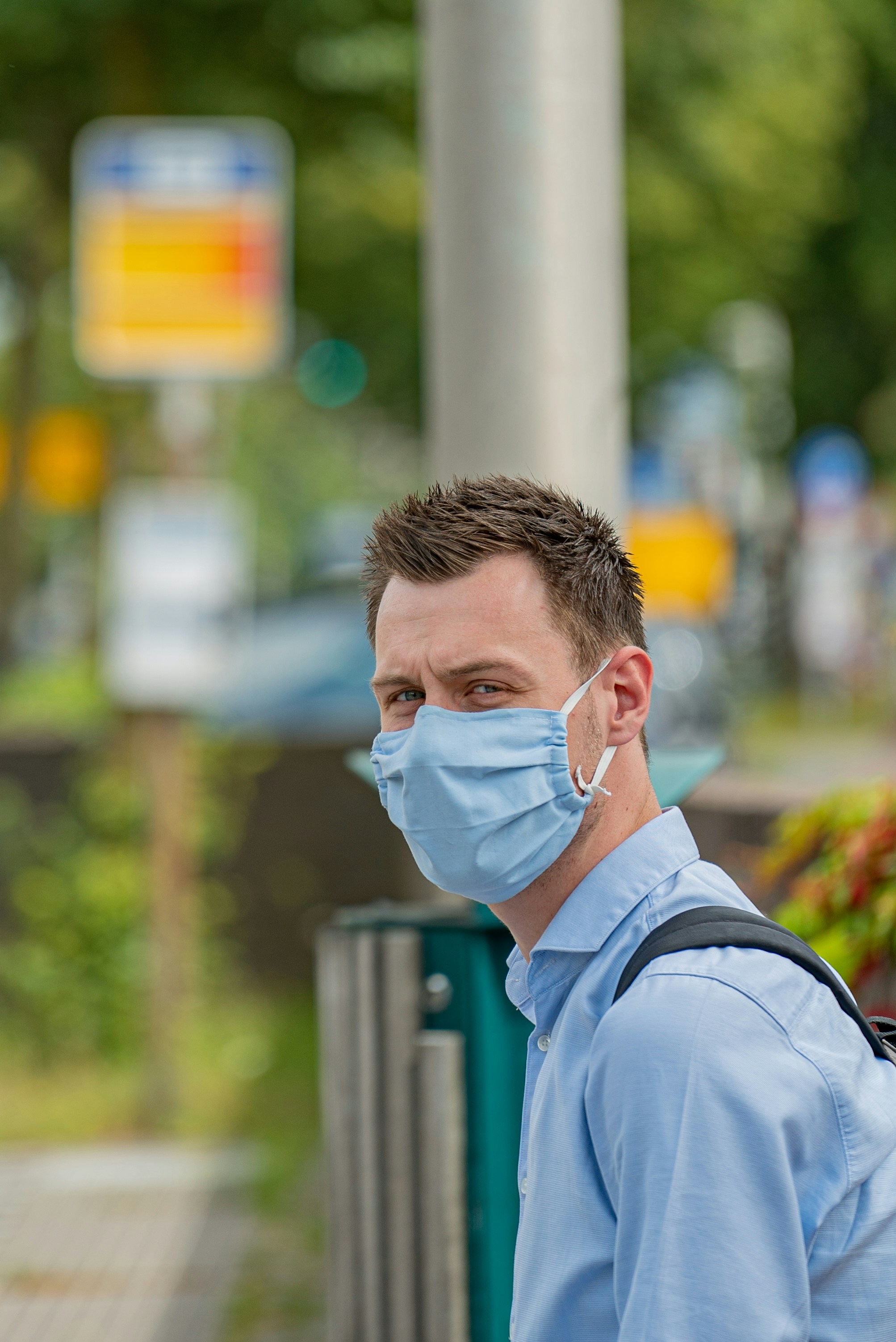 man in blue dress shirt wearing eyeglasses