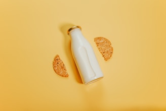 white bottle beside brown cookie