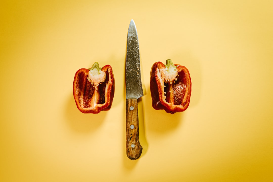 sliced tomato beside silver knife