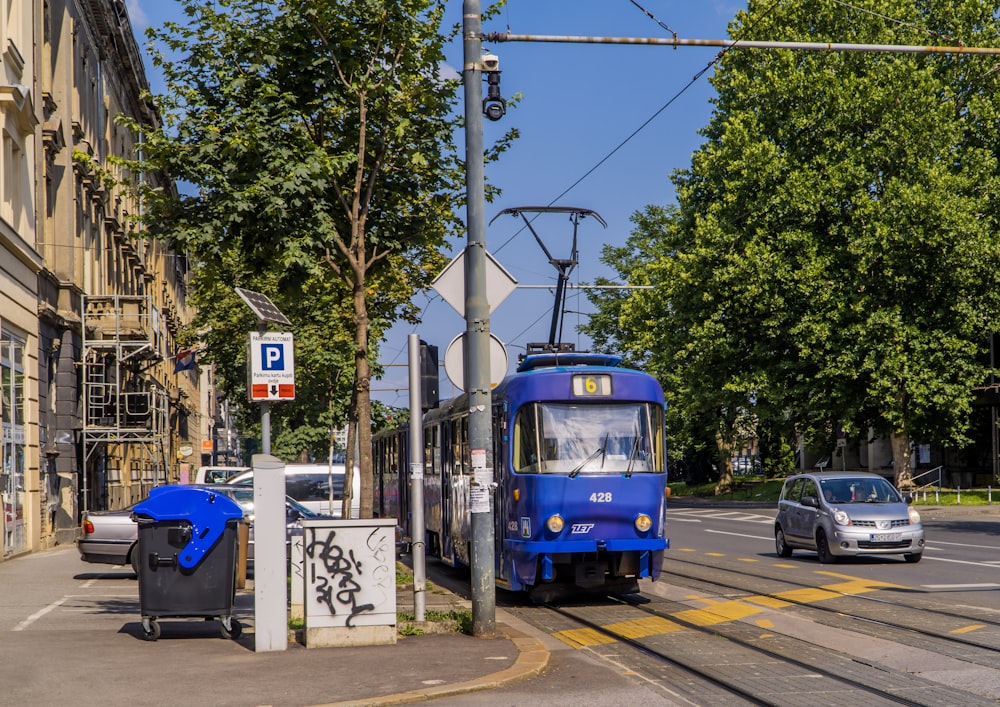 blue and white tram on road during daytime