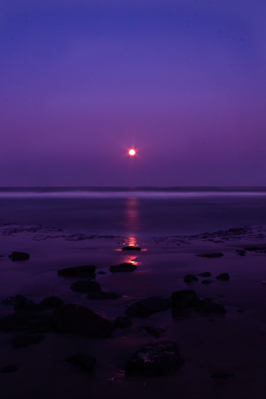 sunset over the sea with rocks in Tramandaí Brasil