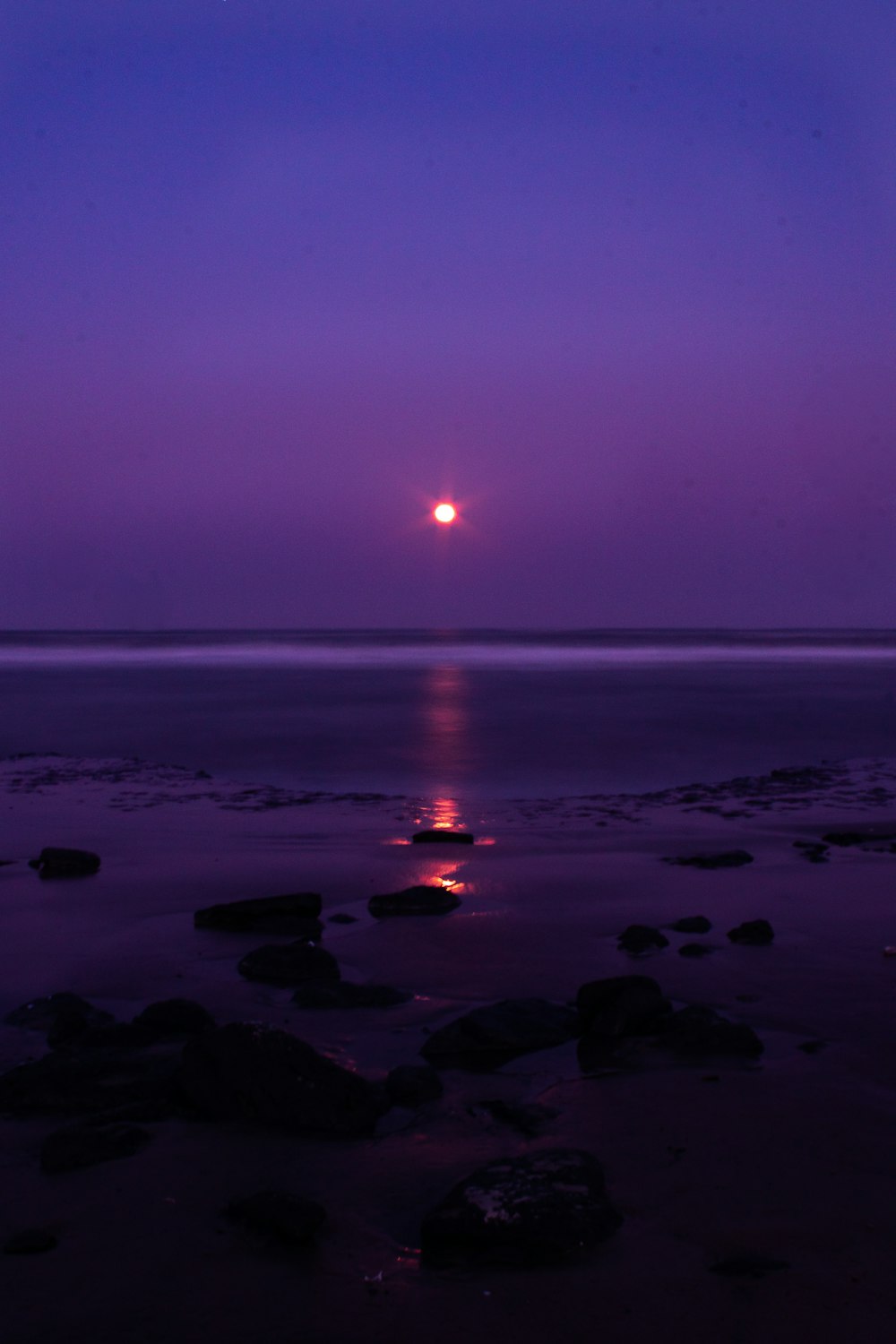 sunset over the sea with rocks