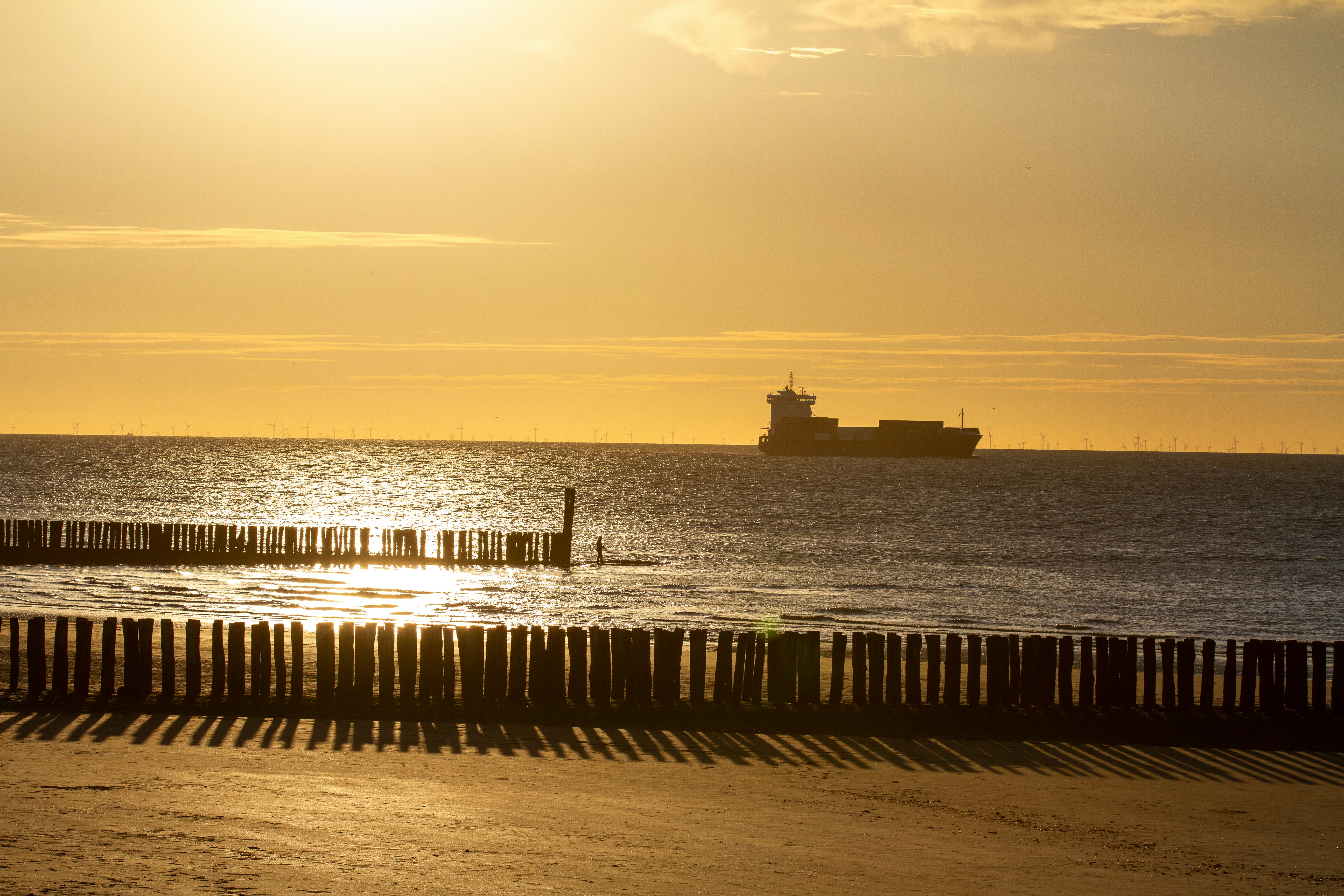 silhouette of ship on sea during sunset