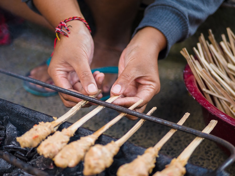 person holding brown and black grilled meat