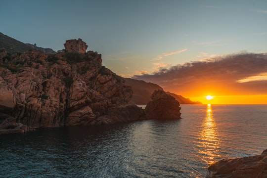 brown rock formation on sea during sunset in Corse France