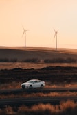 A Shepway Taxis car driving along a scenic Kent countryside road at sunset.