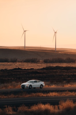A Shepway Taxis car driving along a scenic Kent countryside road at sunset.