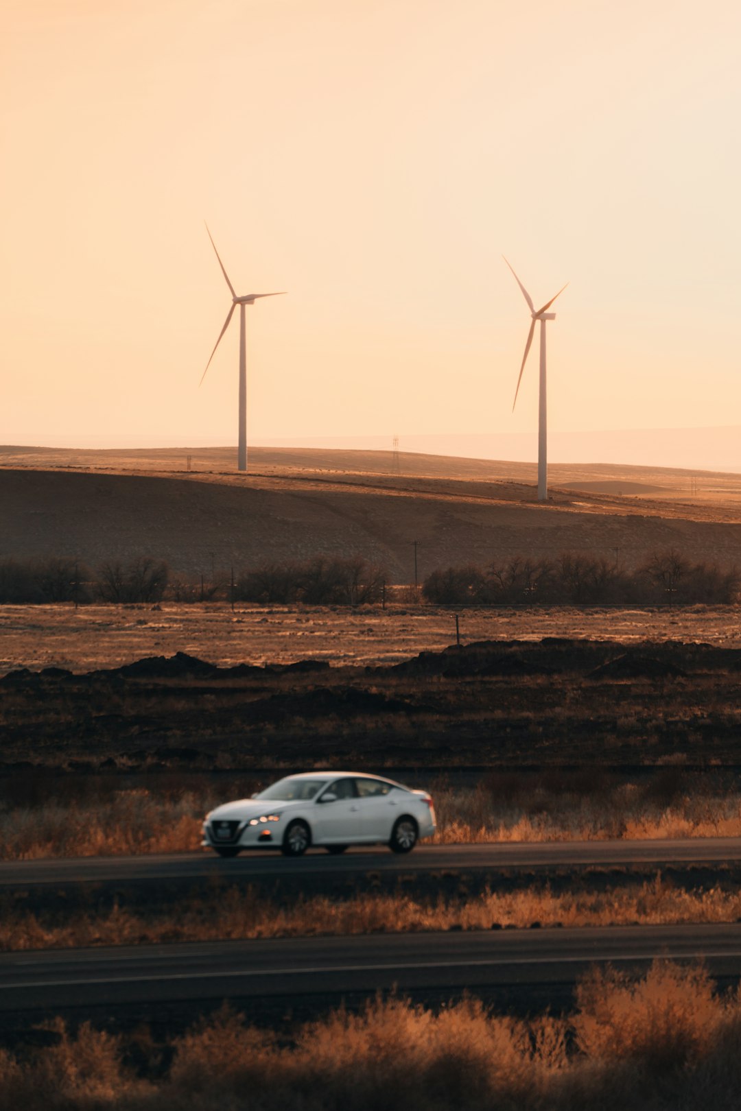 silver sedan on brown field during daytime