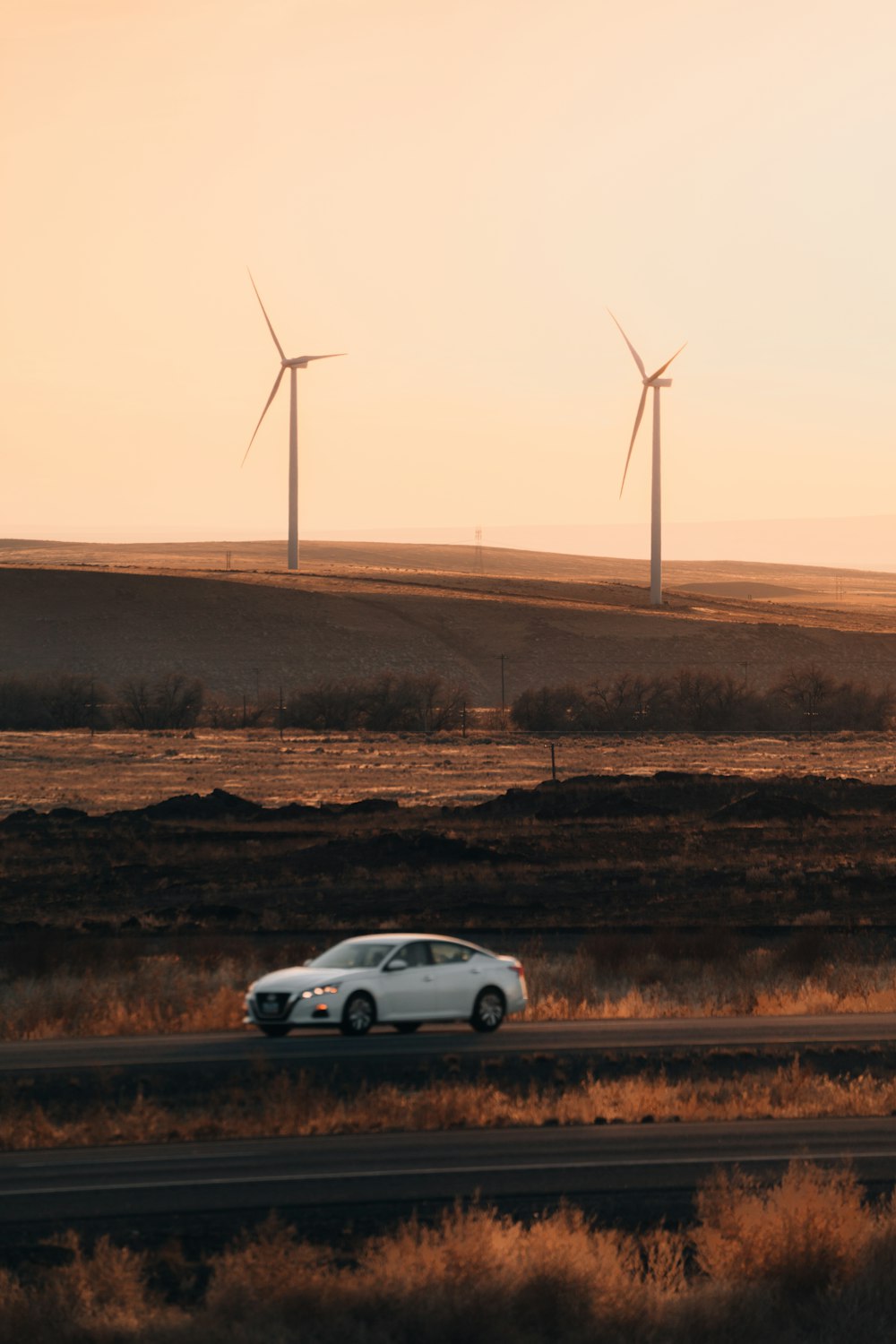 silver sedan on brown field during daytime