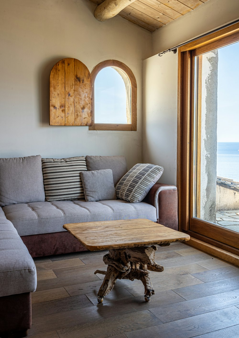 brown wooden framed gray padded armchair