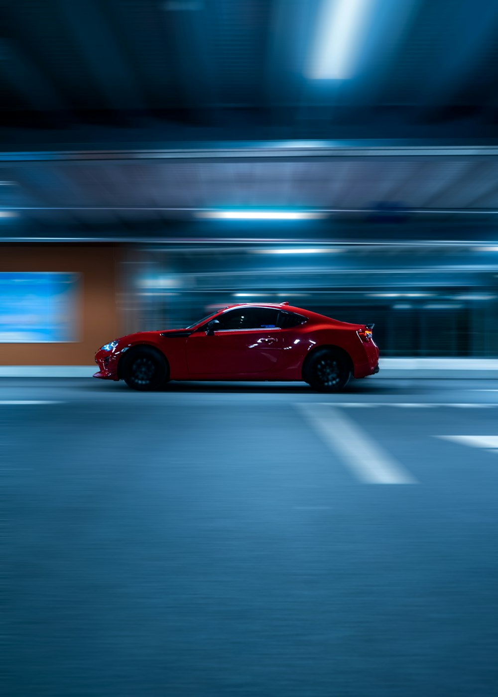 red coupe on road during night time